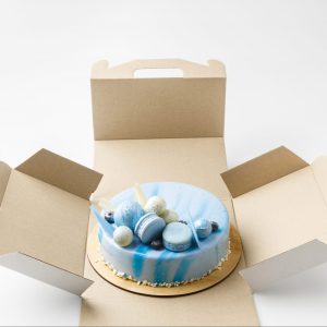 blue tasty cake in opened box isolated on white
